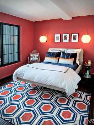 Dormitor cu pat dublu alb pereti rosii si pardoseala neagra cu covor cu model geometric alb-negru-rosu