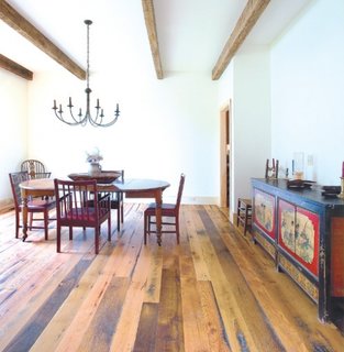 Loc pentru luat masa amenajat rustic cu dusumea din lemn si grinzi de lemn pe tavan